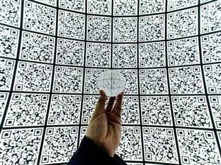 a wall  of QR codes as seen through a crystal ball